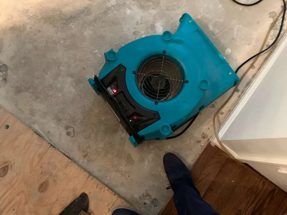Air mover drying subfloor during Leak Detection & Repair in Ambler